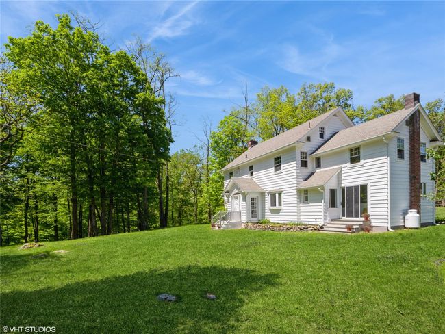 Back of house with a chimney, a yard, and roof with shingles | Image 16