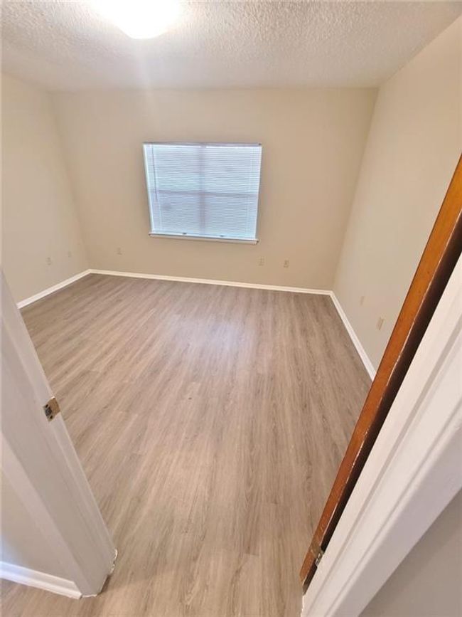 Unfurnished room with light wood-style flooring and a textured ceiling | Image 10