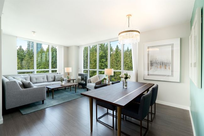 Dining area with a chandelier, dark wood-style floors, and baseboards | Image 8