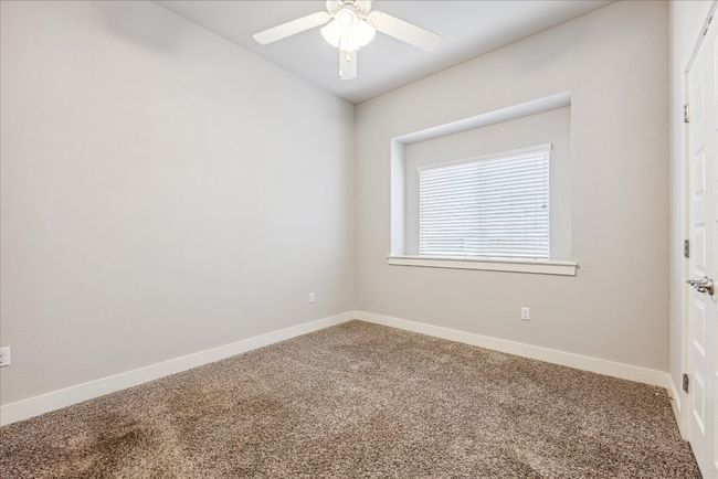 Unfurnished room with carpet floors, a ceiling fan, and baseboards | Image 23