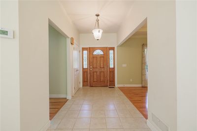 The open foyer serves as a welcoming entrance for your guests. The formal dining room and office are open to the space. | Image 3