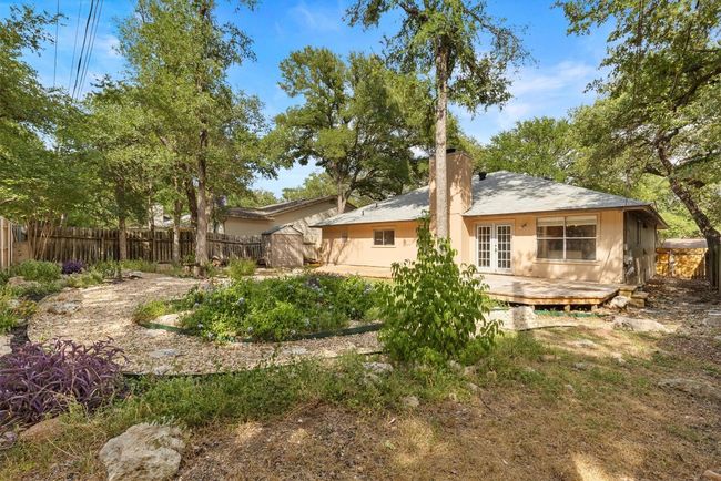 A serene and quiet space, the backyard is beautifully landscaped, offering the perfect spot to relax or entertain | Image 22