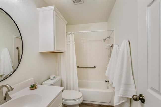 The secondary bathroom has updated lighting, flooring and fixtures. | Image 18