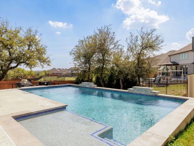 View of pool featuring a fenced in pool, a fenced backyard, and a patio area | Image 31