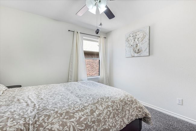 Carpeted bedroom with ceiling fan and baseboards | Image 28