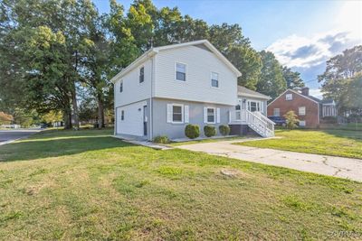 View of front of house with a front lawn from street corner | Image 3