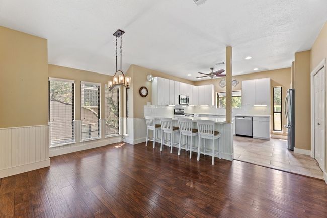Open kitchen and dining with breakfast bar. | Image 11