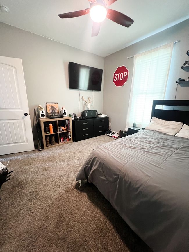 Bedroom featuring ceiling fan and carpet flooring | Image 16