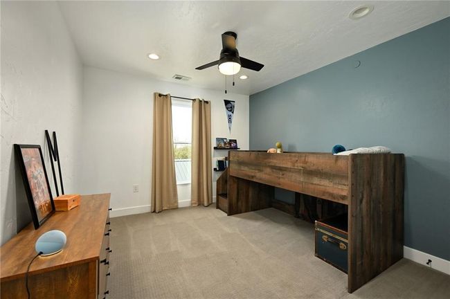 Carpeted secondary bedroom with ceiling fan | Image 43
