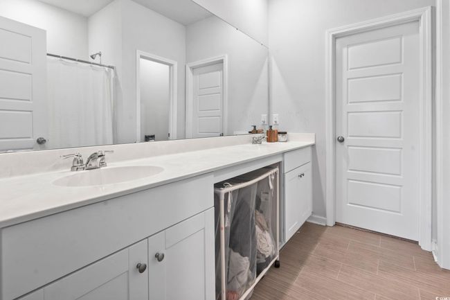 Full bathroom featuring double vanity and baseboards | Image 7