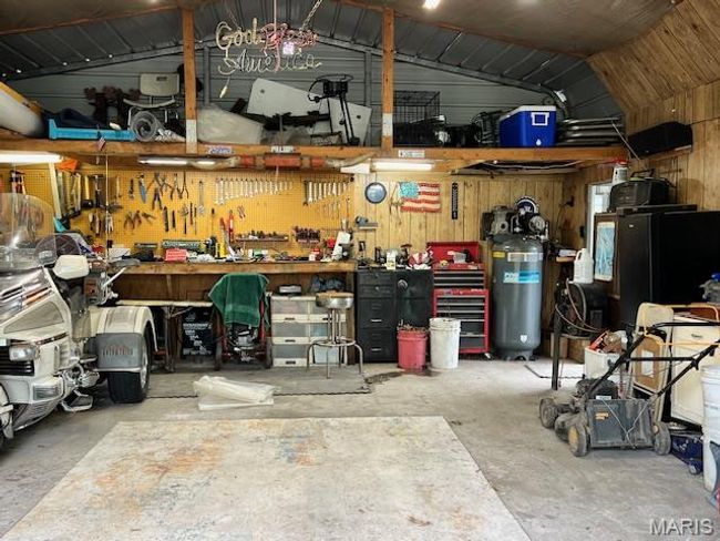 Garage with a workshop area | Image 25
