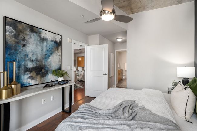 Bedroom featuring wood finished floors, ensuite bathroom, and a ceiling fan | Image 9