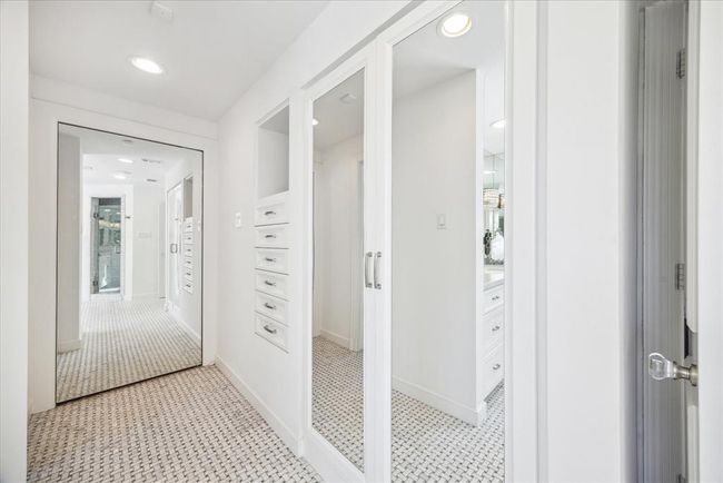 Behind the mirrored wall is one of the three spacious walk-in closets. | Image 27