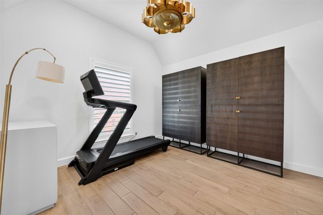 Versatile flex space with vaulted ceiling and wood-look flooring, ideal for a home office, workout room, or hobby area. A large window brings in natural light, and the neutral finish makes it easy to personalize. | Image 20