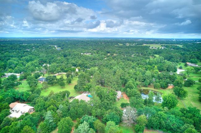 Aerial view of property and surrounding area featuring a forest | Image 11