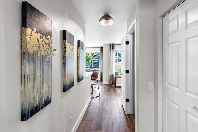 Hallway with dark wood finished floors and baseboards | Image 24