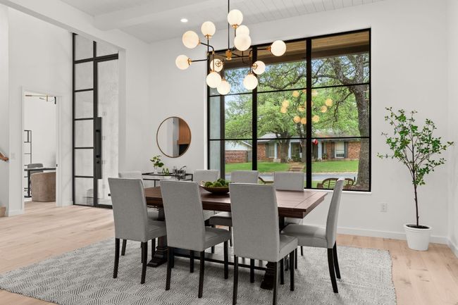 The formal dining room has large windows to allow for natural light. | Image 4