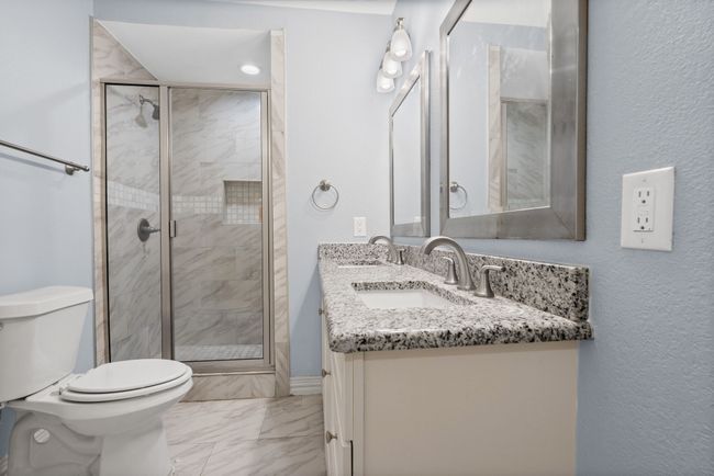 Full bathroom featuring marble finish floors, vanity, and a stall shower | Image 14