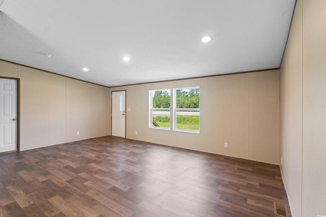 Empty room with wood finished floors, recessed lighting, and crown molding | Image 27