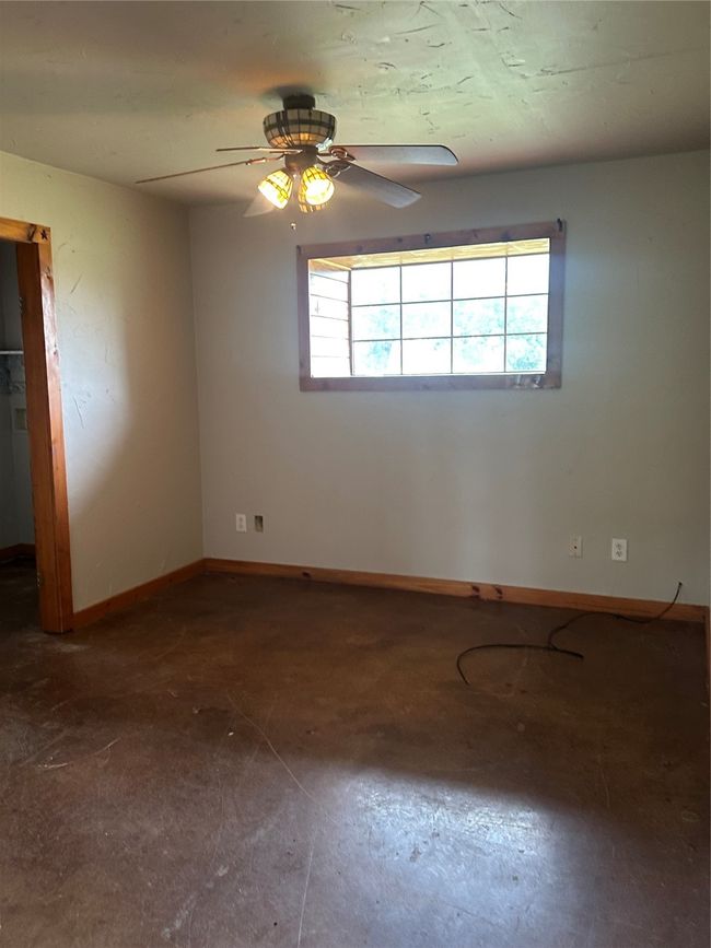 Spare room with baseboards and ceiling fan | Image 5
