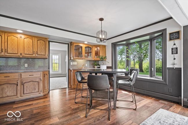 dining space with plenty of natural light, a baseboard heating unit, dark wood finished floors, and recessed lighting | Image 13