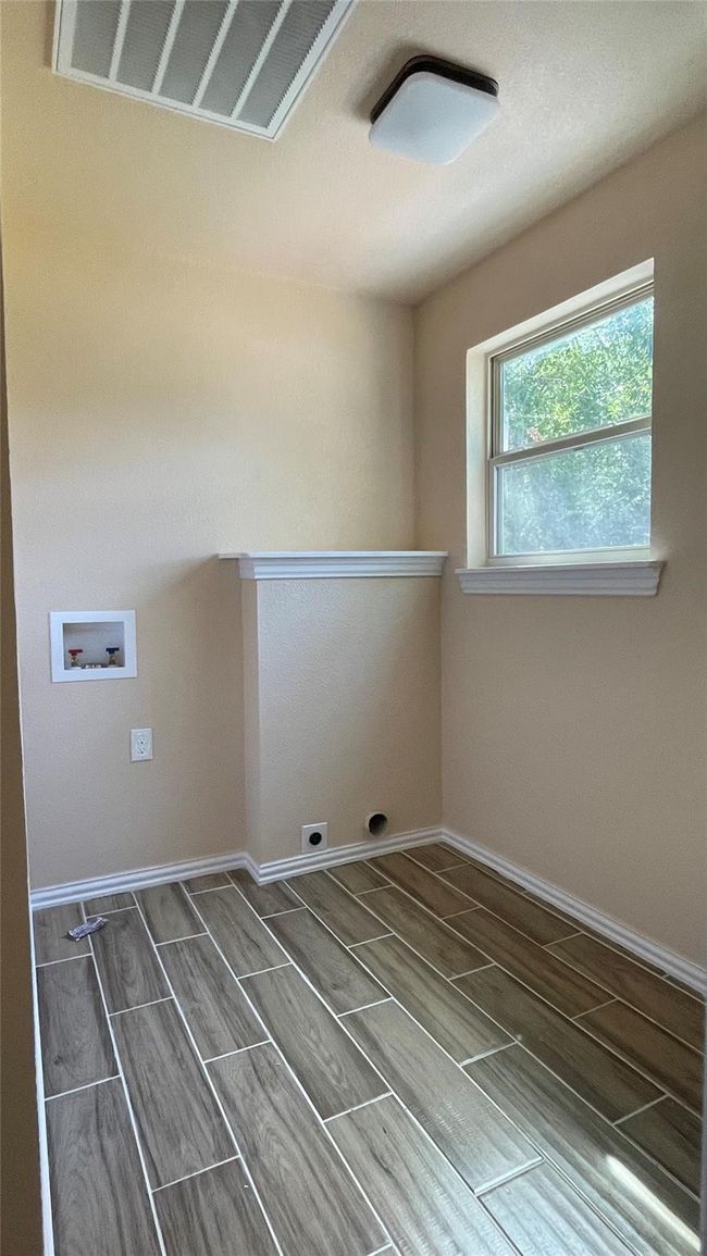 Washroom with visible vents, baseboards, laundry area, hookup for a washing machine, and electric dryer hookup | Image 8
