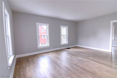 Empty room with light wood-type flooring | Image 3