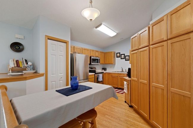 Kitchen boasts ample cabinetry and pantry | Image 7
