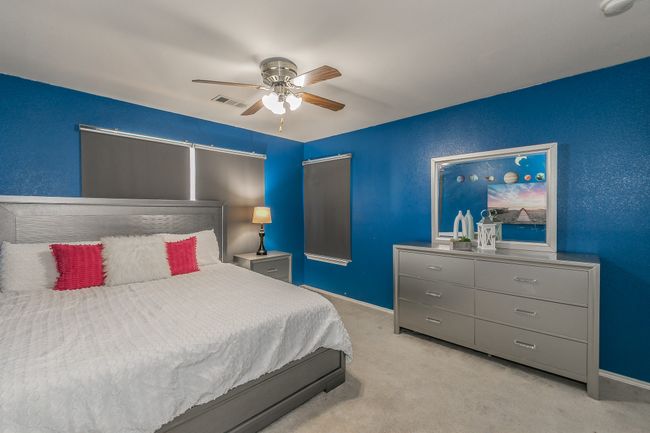 Bedroom featuring light carpet and ceiling fan | Image 27