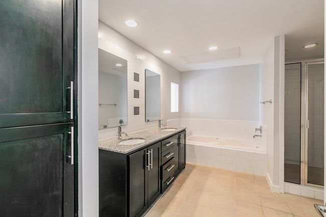 Enjoy the rare convenience of two separate bathroom access points—one to the hallway for guests or shared use, and one to the en suite primary bath. | Image 12