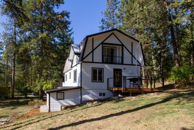 Rear view of house with a yard and a deck | Image 3