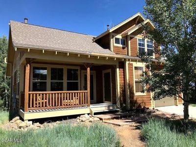 Rear view of property featuring covered porch | Image 1