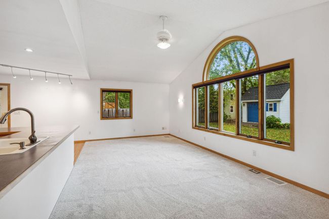Family room has great natural light with all the windows and custom roundtop window. | Image 12