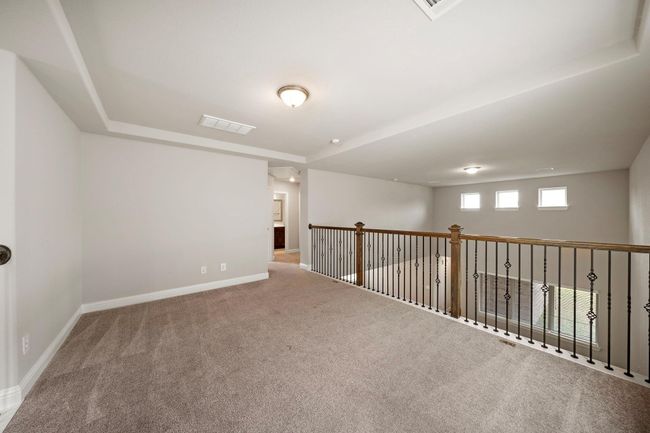 As you walk up the stairs to the 2nd floor, you are greeted with a game room that overlooks the living room. | Image 20