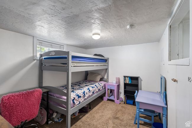 Bedroom featuring a textured ceiling and carpet | Image 14