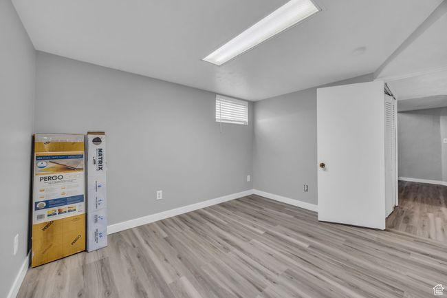 Below grade area with wood finished floors and baseboards | Image 21