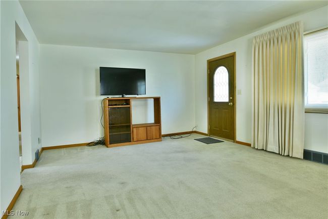 Foyer entrance with baseboards, visible vents, and carpet | Image 8