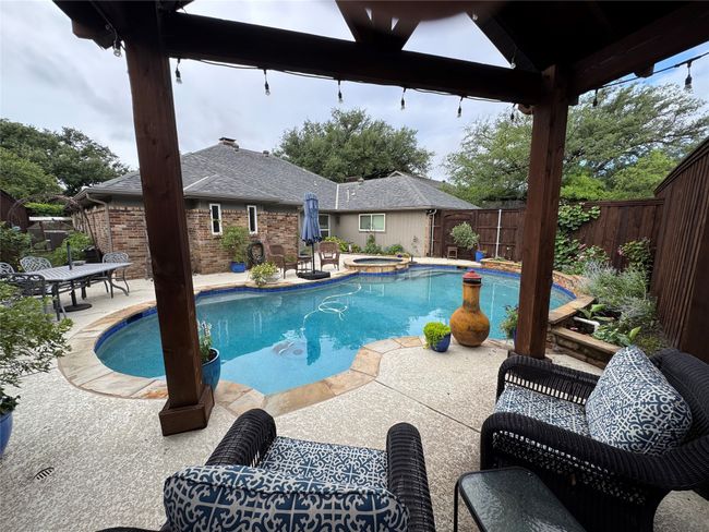 View of swimming pool featuring a fenced backyard, a patio area, a gazebo, and a pool with connected hot tub | Image 30