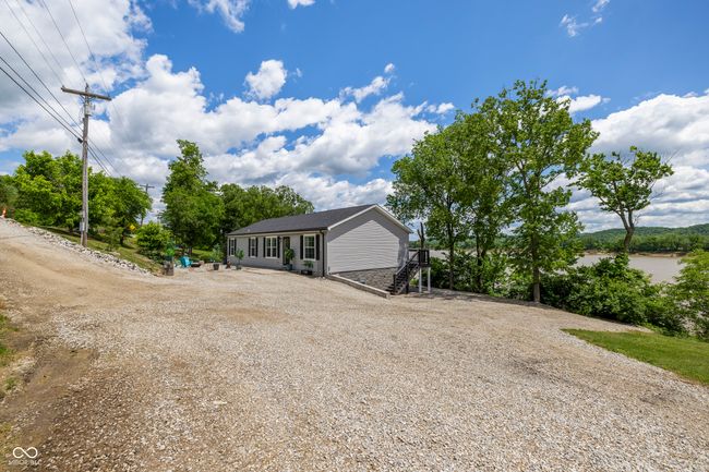 view of front of home featuring driveway and roof with shingles | Image 63