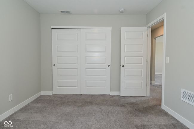 unfurnished bedroom featuring visible vents, carpet flooring, and a closet | Image 37