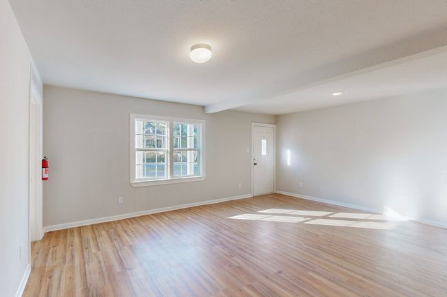 Unfurnished room featuring beam ceiling and light hardwood / wood-style floors | Image 8