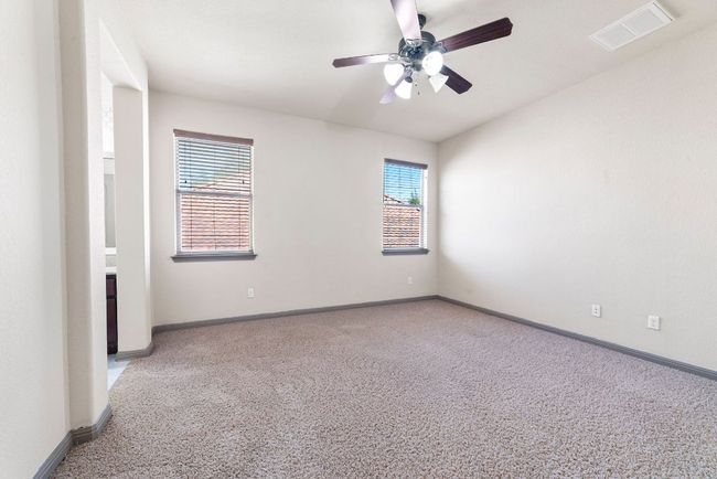 Empty room featuring light carpet and ceiling fan | Image 33