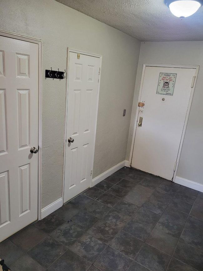 Entryway featuring baseboards and a textured ceiling | Image 4