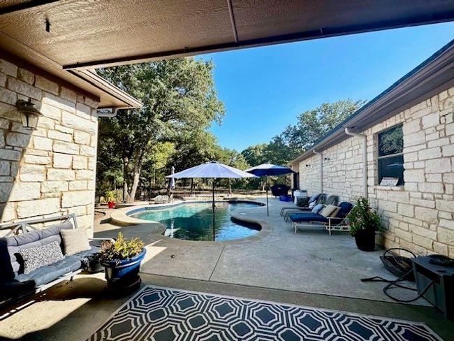 View of swimming pool featuring an outdoor living space and a patio | Image 36