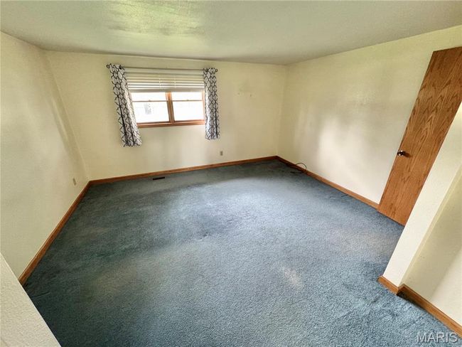 Carpeted empty room featuring baseboards | Image 13