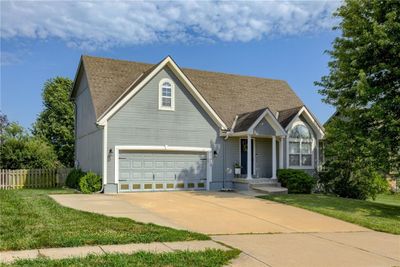 View of front of home featuring a garage and a front yard | Image 2