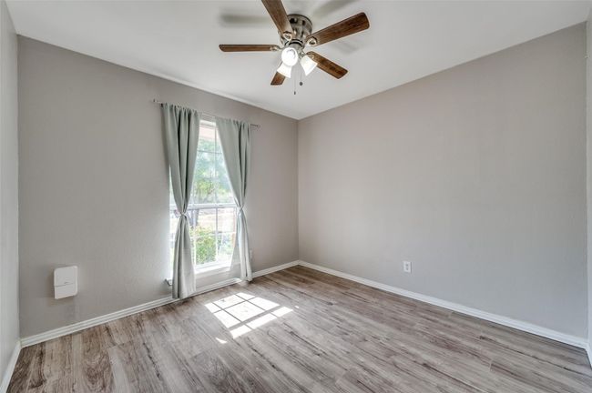 Secondary Bedroom with baseboards, ceiling fan, and light wood-type flooring | Image 19