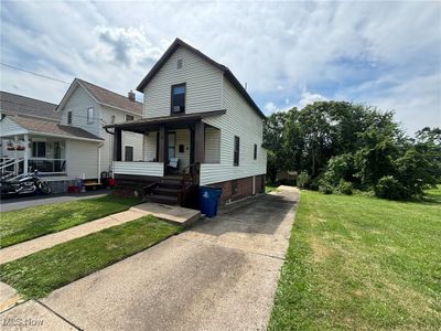 View of front of property featuring covered porch and a front yard | Image 2