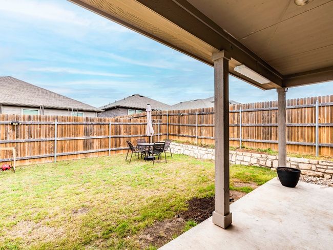 View of yard featuring a fenced backyard and a patio area | Image 27