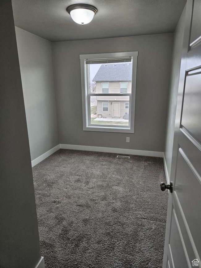 Unfurnished room with carpet floors, baseboards, and a textured ceiling | Image 11